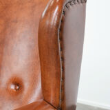 Wingback chair made of sheep leather with black piping in good condition