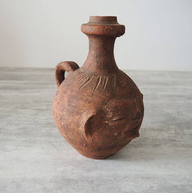 Old anthropomorphic terracotta vase pitcher