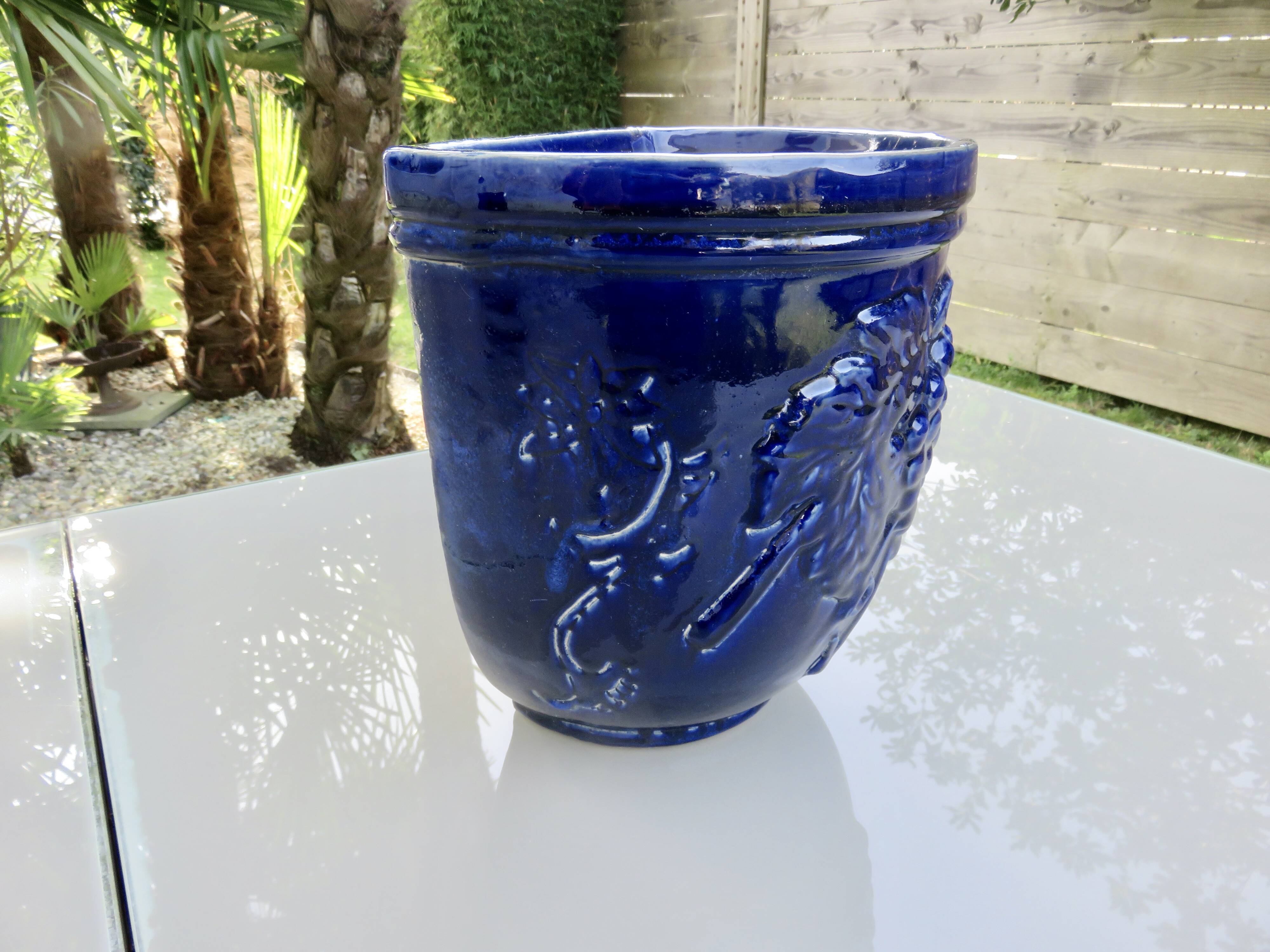 Wall pot in glazed blue terracotta with a grape motif, 1970s.