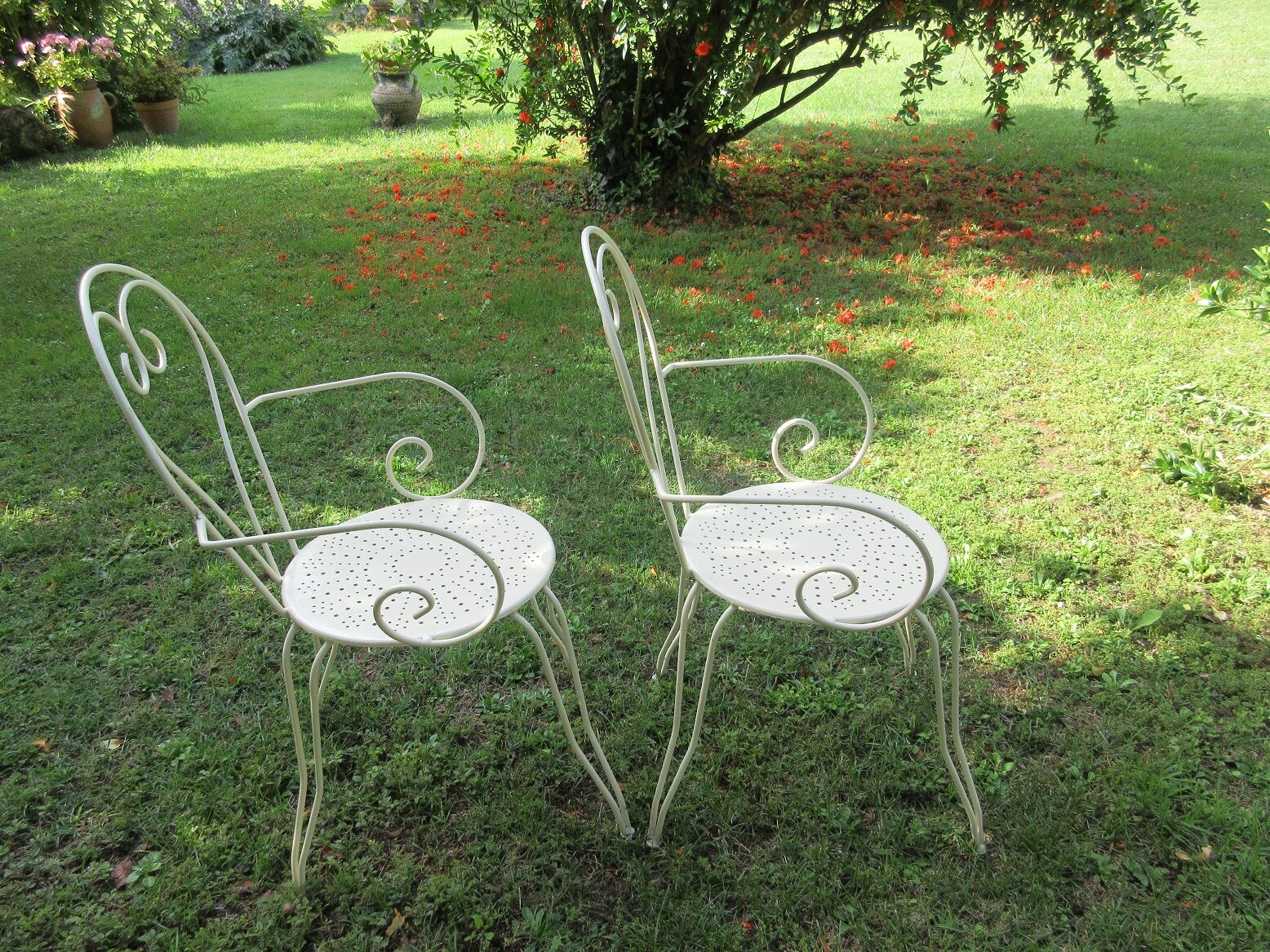 Pair of wrought iron armchairs