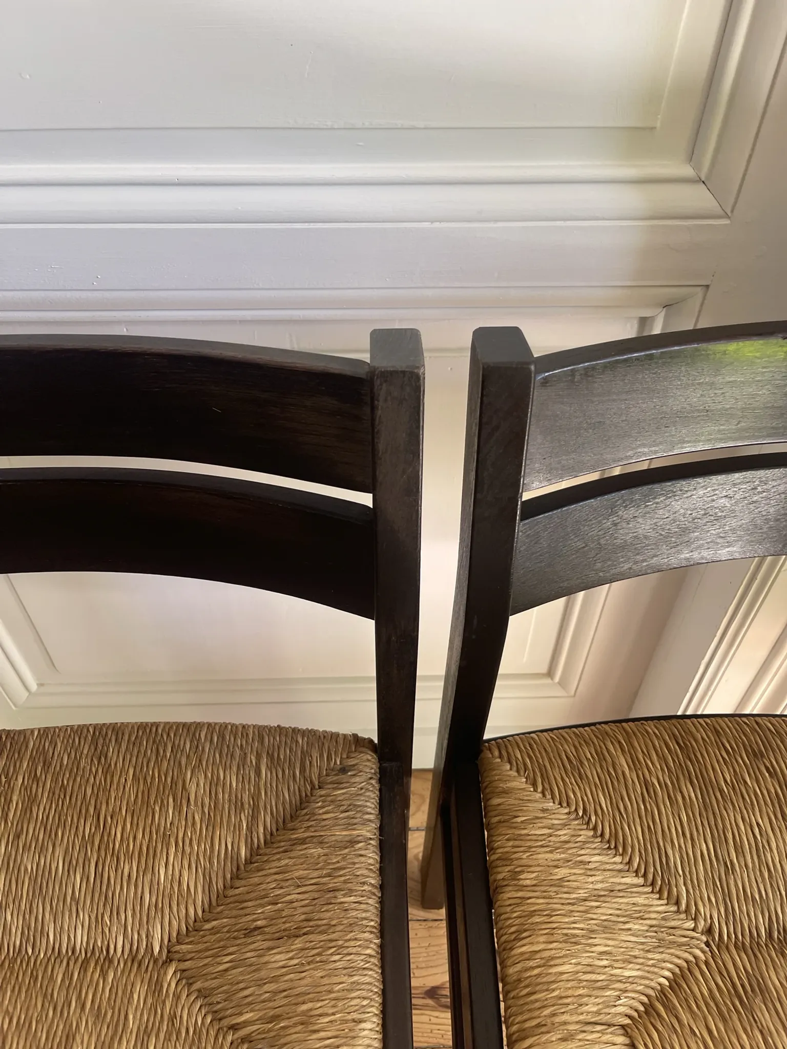 Pair of straw-seated wooden chairs in the regain style.