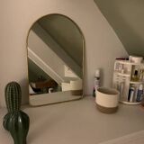Brass wall mirror in the shape of a handmade holder