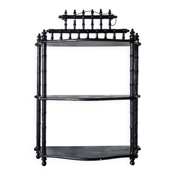 Small black wooden wall shelf with 3 tiers.