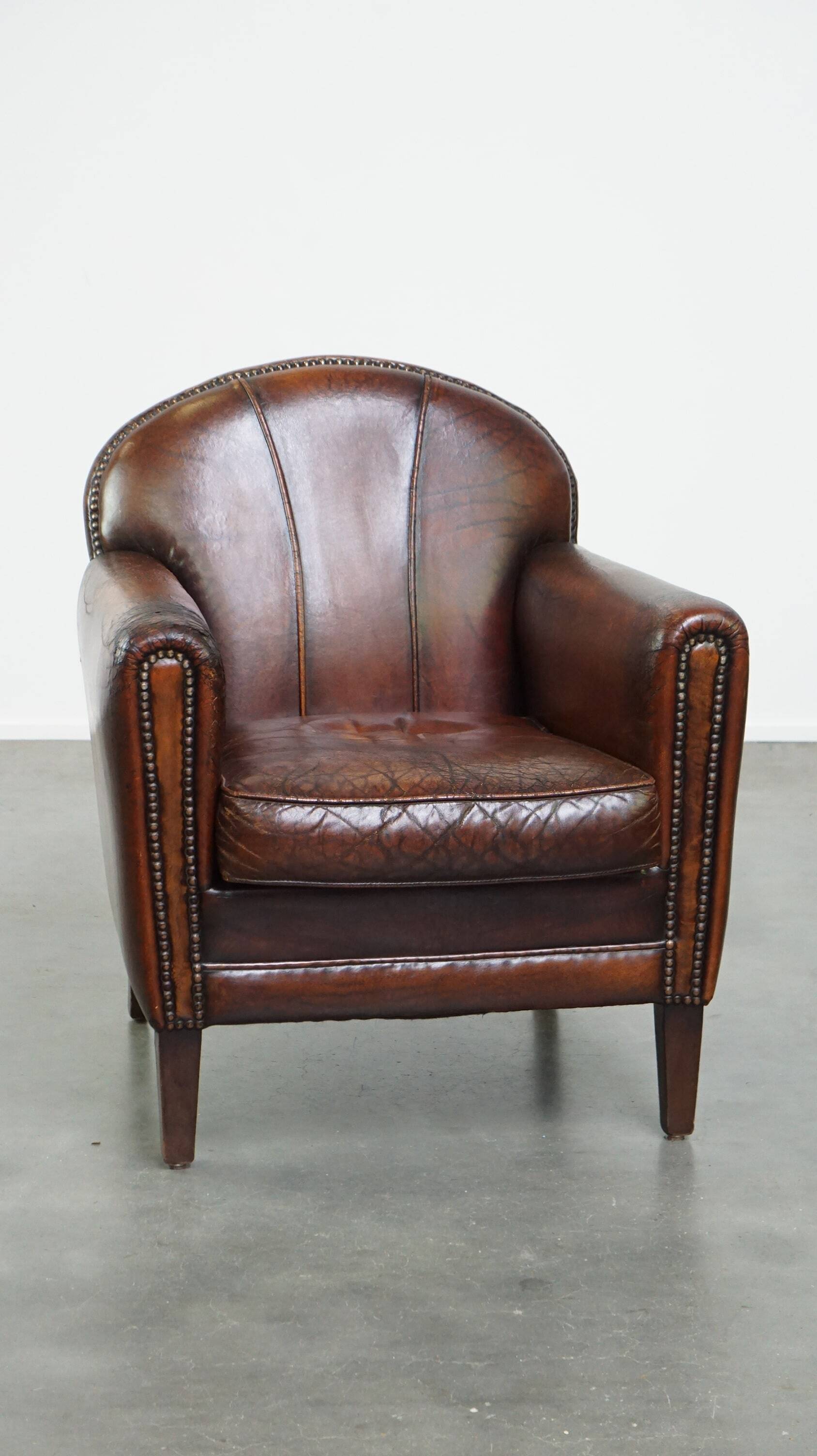 A vintage-style armchair with character, upholstered in beautifully patinated sheepskin.