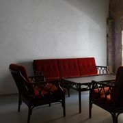 Dark rattan 3-seater sofa with red velour cushions | 1980s