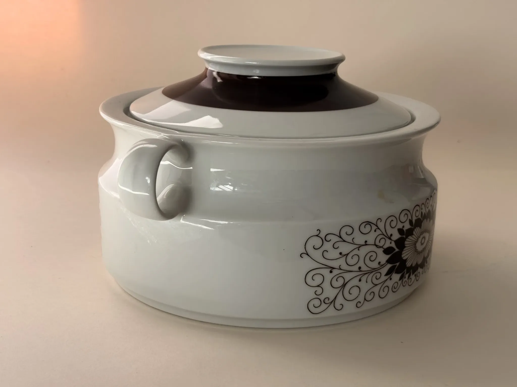 Porcelain soup tureen by Winterling, decorated with brown flowers.
