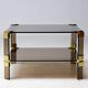 Hollywood Regency coffee table in brass and smoked glass, chic two-tier coffee table.