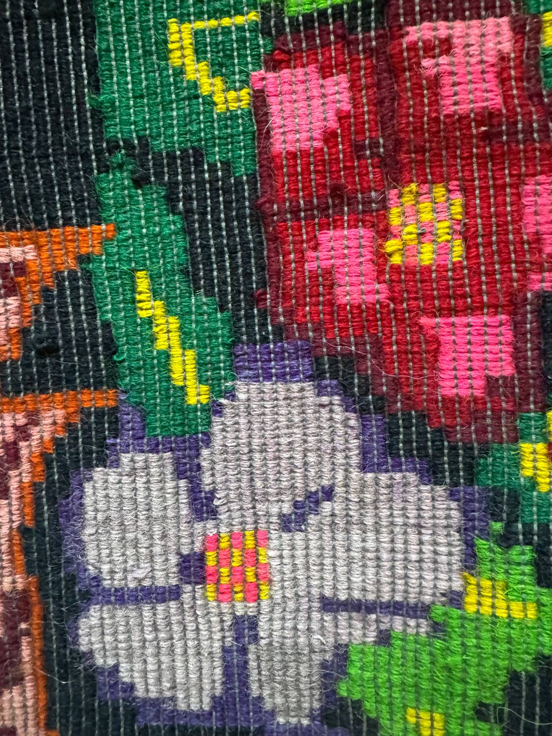 Bohemian floral design, handwoven wool rug, black background with colorful flowers