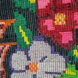 Bohemian floral design, handwoven wool rug, black background with colorful flowers