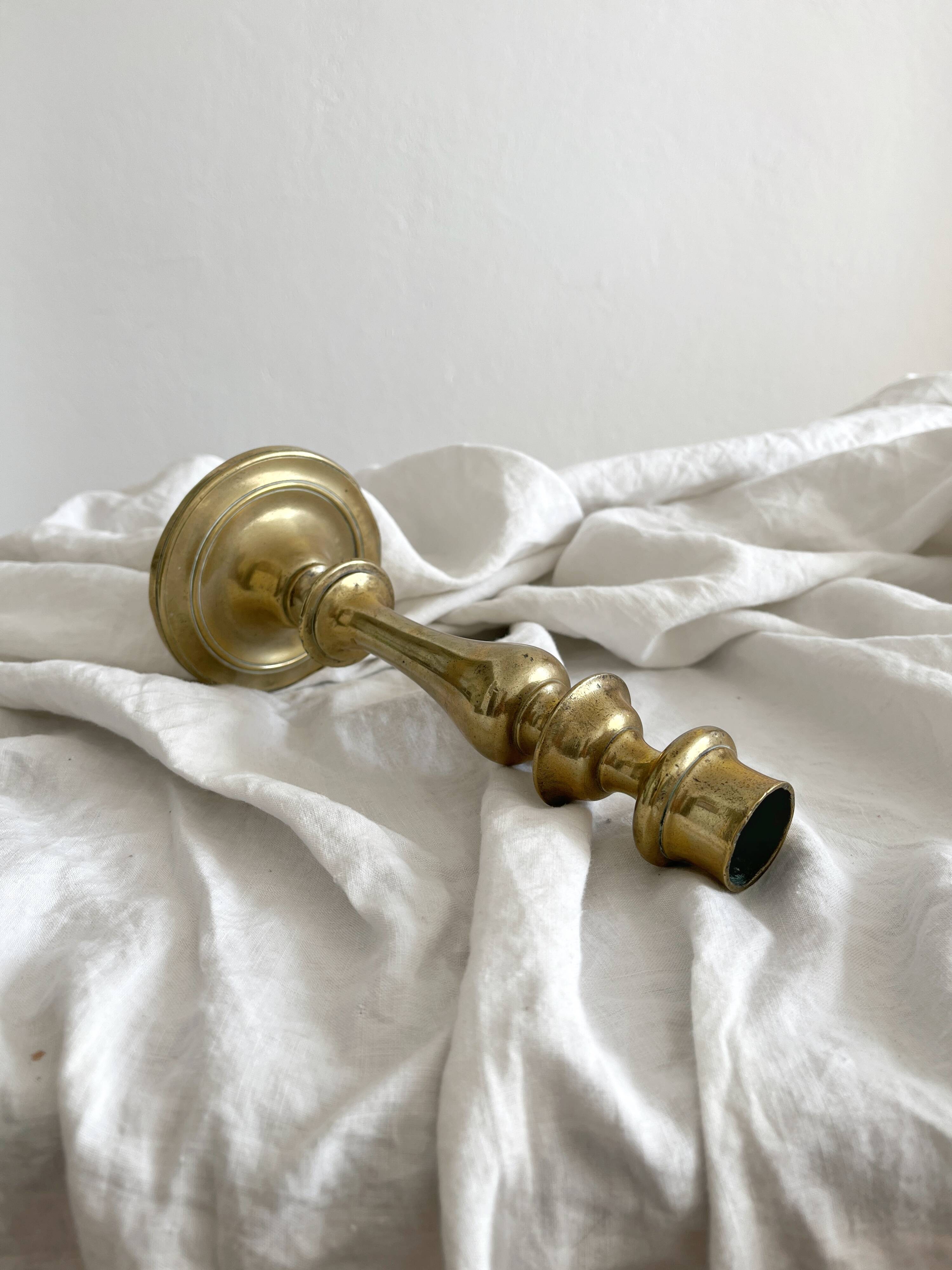 Antique brass candlestick in vintage baluster shape