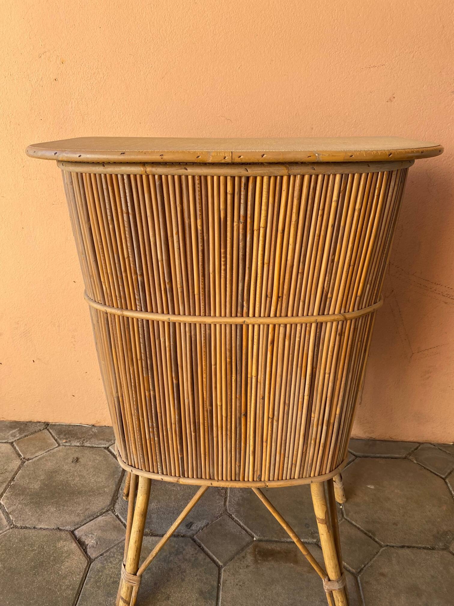 Vintage rattan bar from the 60s with rounded shapes and a shelf for glasses
