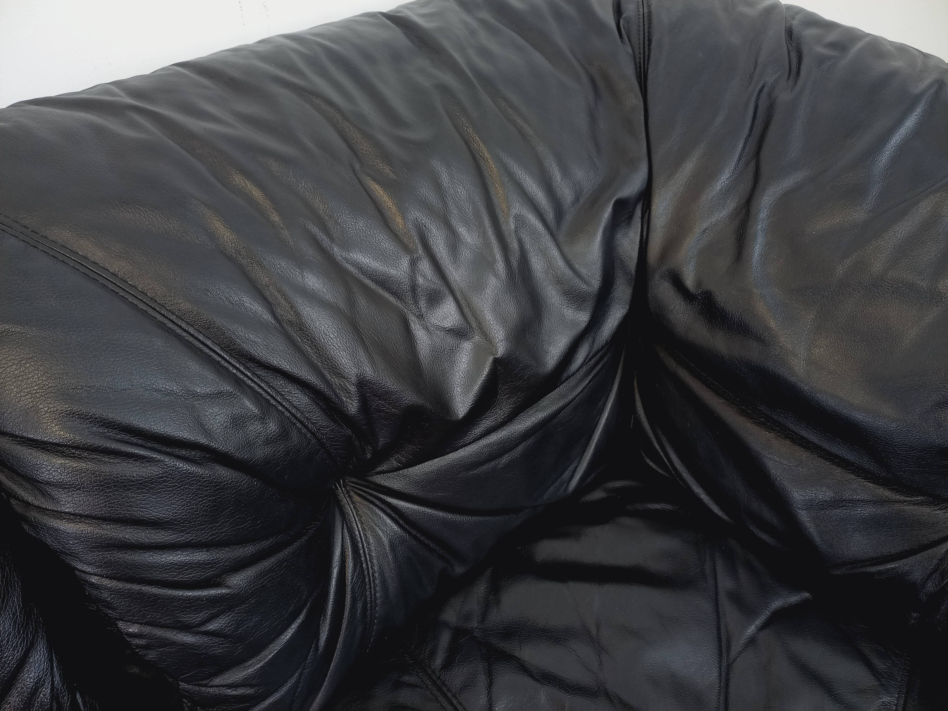 Vintage corner sofa composed of 3 modules in black leather with integrated bed.