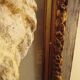 Antique gilded frame with stone lion head ornament on plexiglass