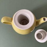 Small lemon yellow porcelain teapot with filter