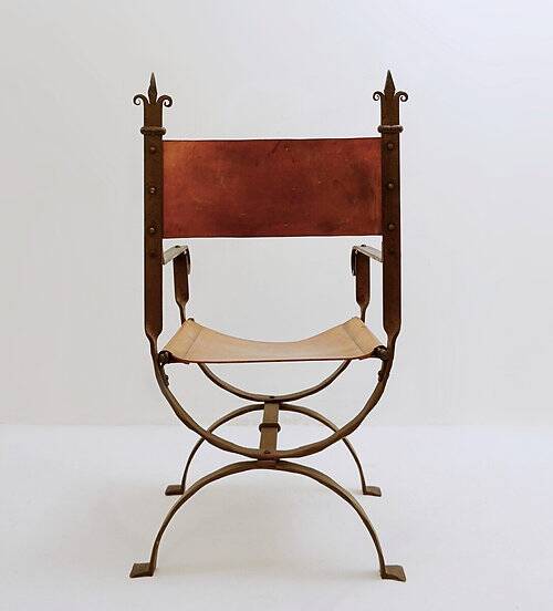 Curule armchair in wrought iron and leather