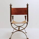 Curule armchair in wrought iron and leather