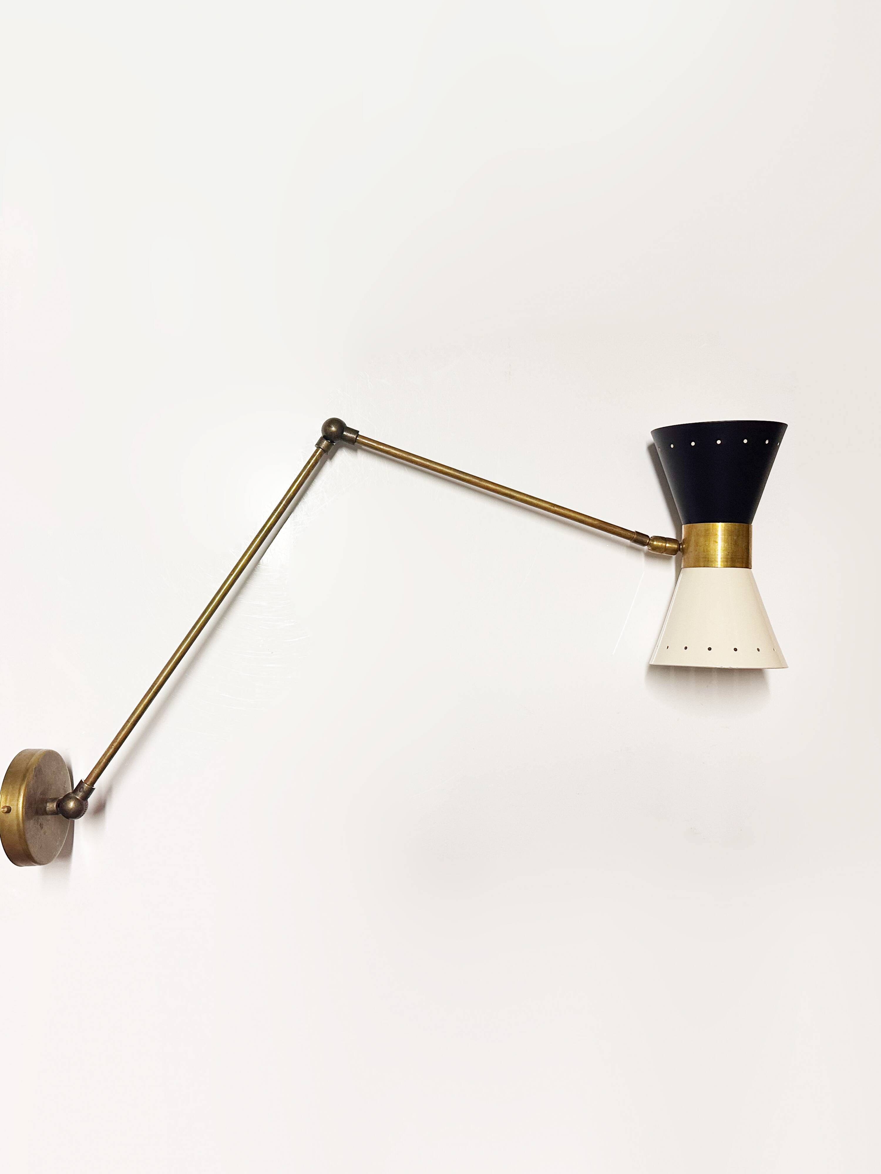 Articulated brass and lacquered iron wall light, 1950s design.