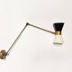 Articulated brass and lacquered iron wall light, 1950s design.