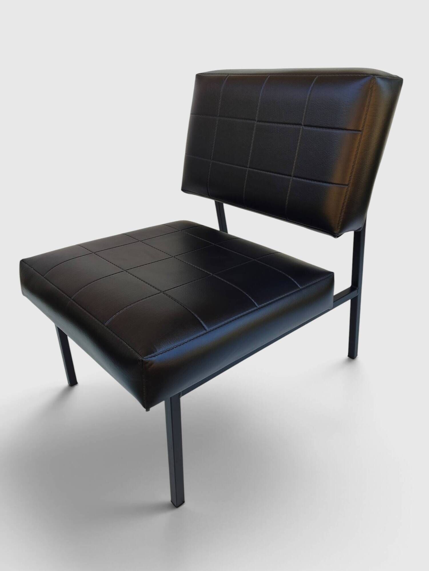 Modernist armchair in black faux leather and metal – 1960s