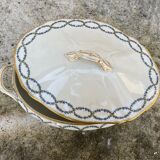 Old soup bowl with a golden border and decorated with small blue flowers