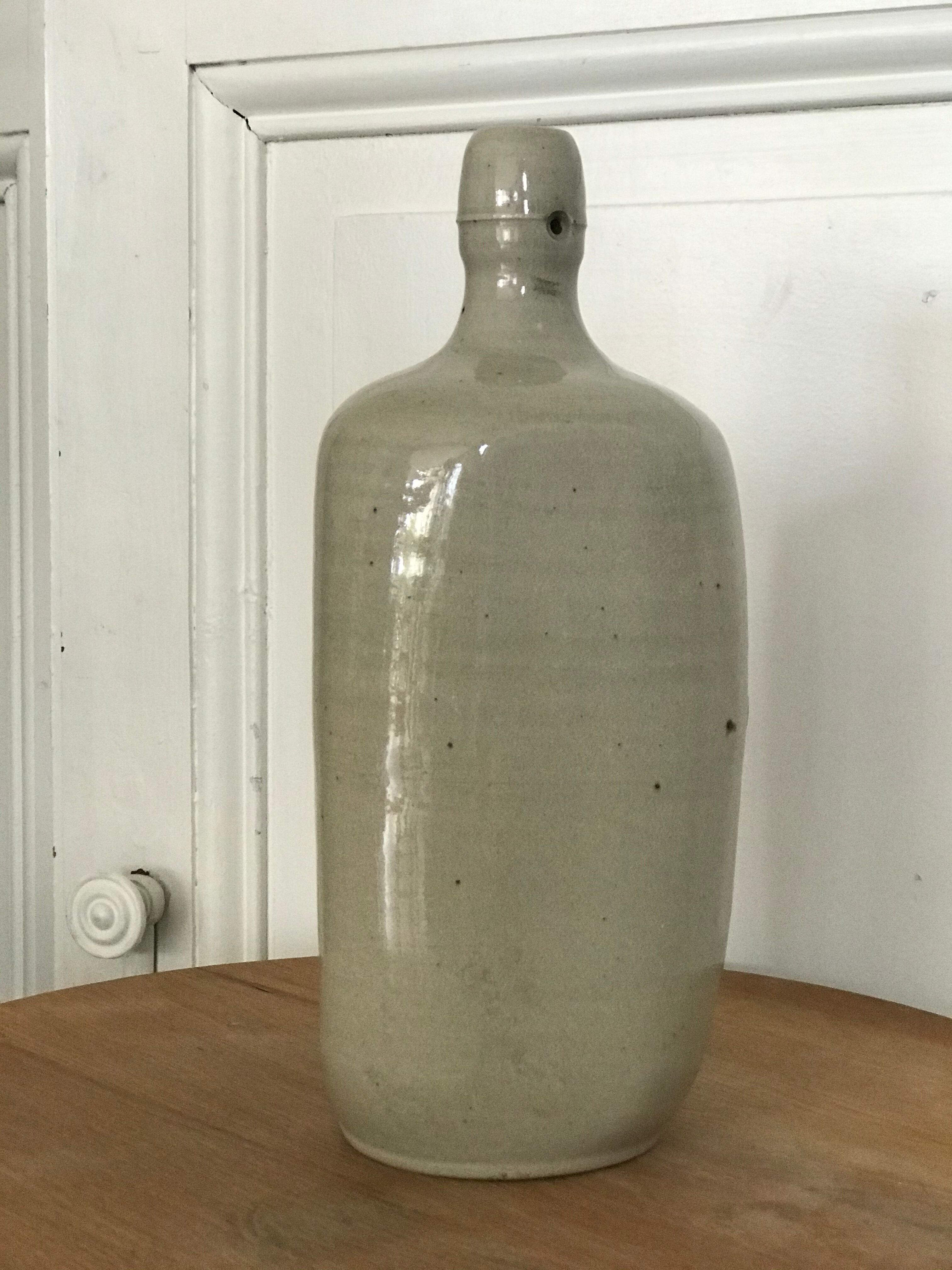 Old light grey ceramic bottle