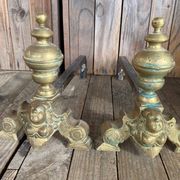 Pair of andirons and grates in cast iron and bronze with gilded grotesques, 17th century
