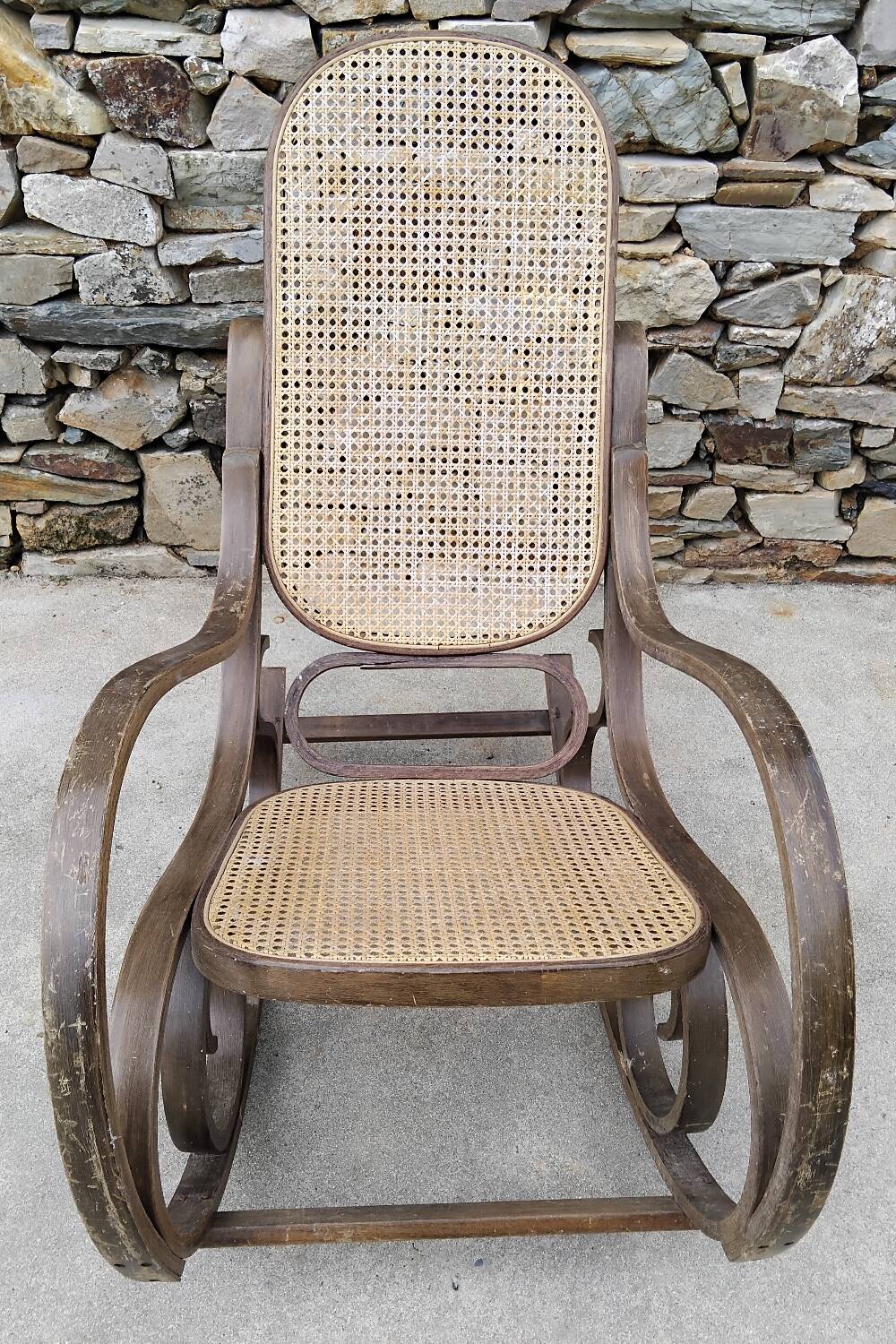 Vintage wooden and cane rocking chair