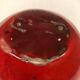 Red ceramic ball vase signed A