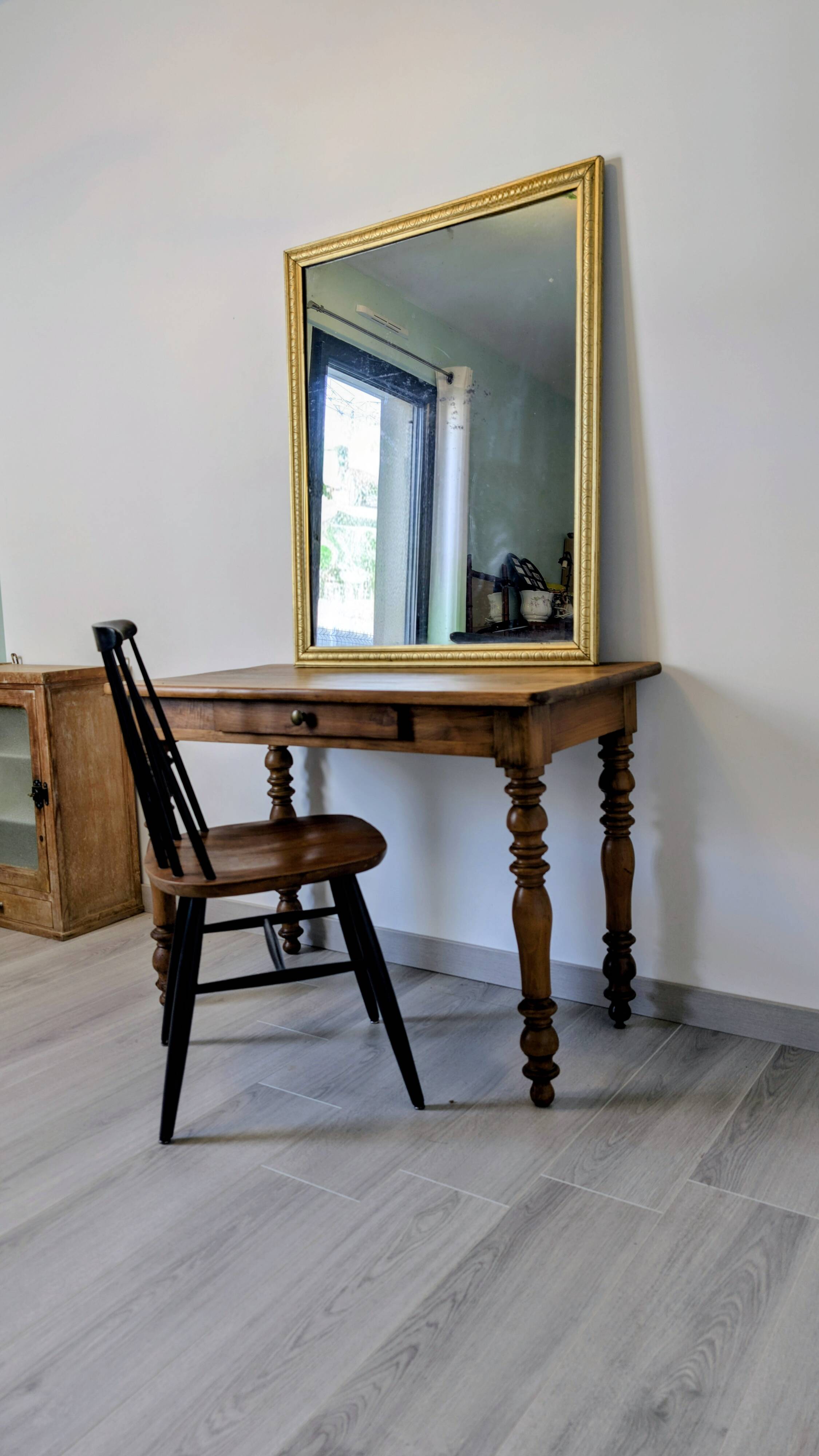 Antique writing table in the Napoleon III style with turned wooden legs.