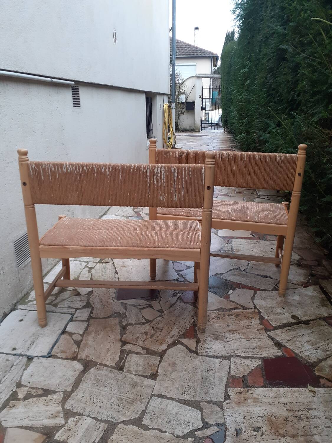 2 wooden and straw benches