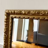 Bevelled mirror in carved gilded wood