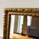 Bevelled mirror in carved gilded wood