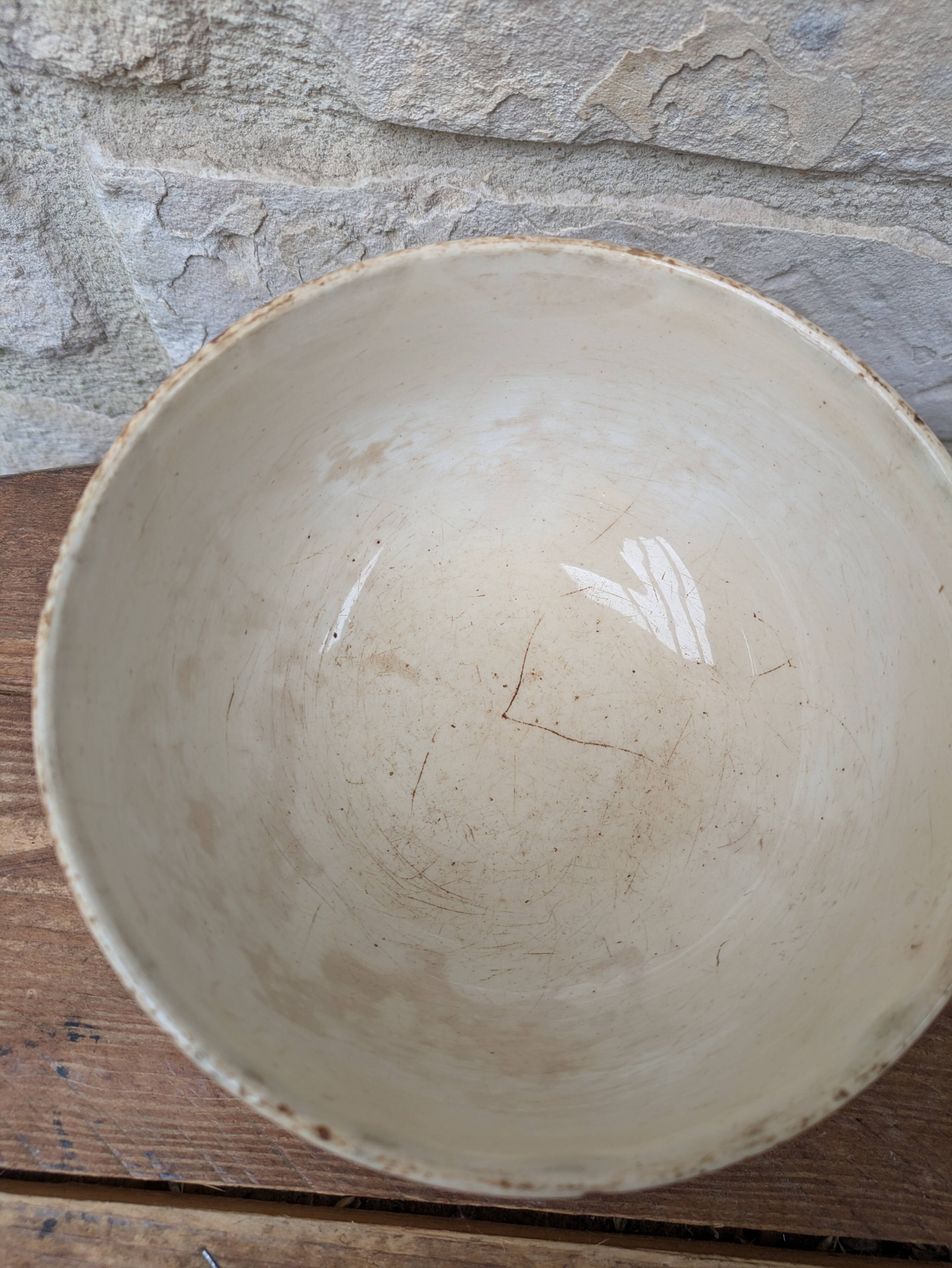 Old opaque porcelain bowl from Gien with a floral decoration.