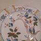 Flat plate in earthenware, hand-painted rural decoration partly in relief,