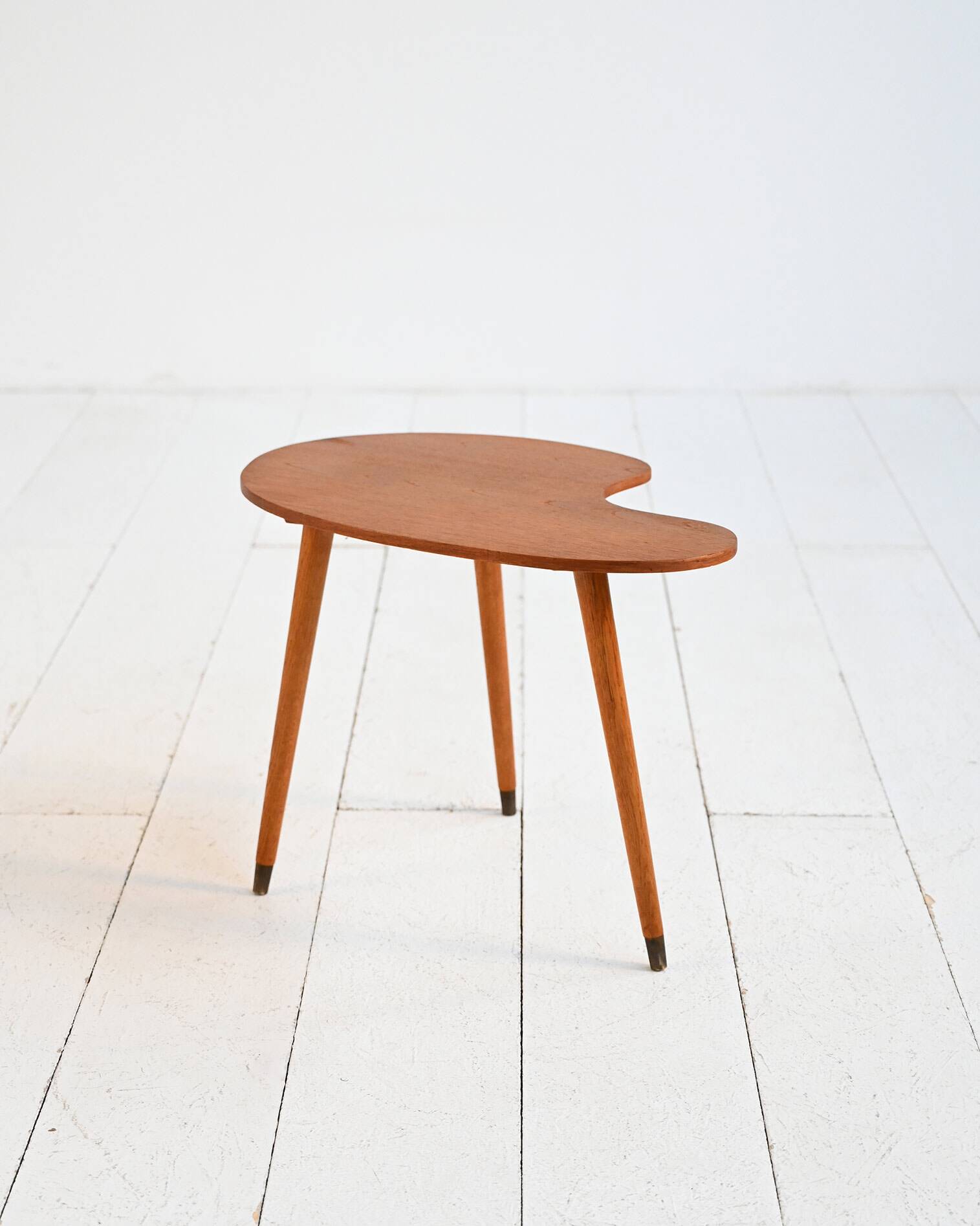 Biomorphic teak and brass side table from the 1950s–1960s