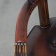 Set of two brown leather Chesterfield dining chairs in English style.