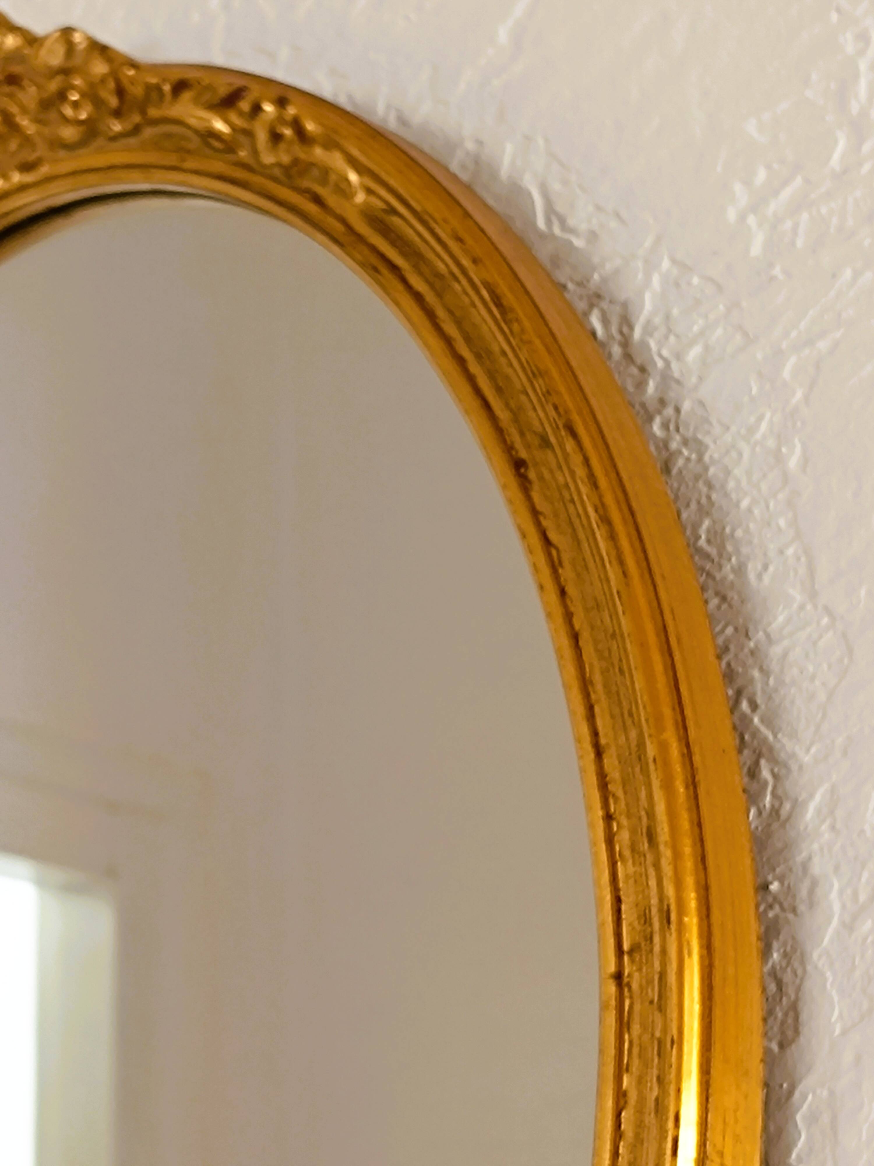 Antique oval-shaped gilded mirror