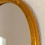 Antique oval-shaped gilded mirror