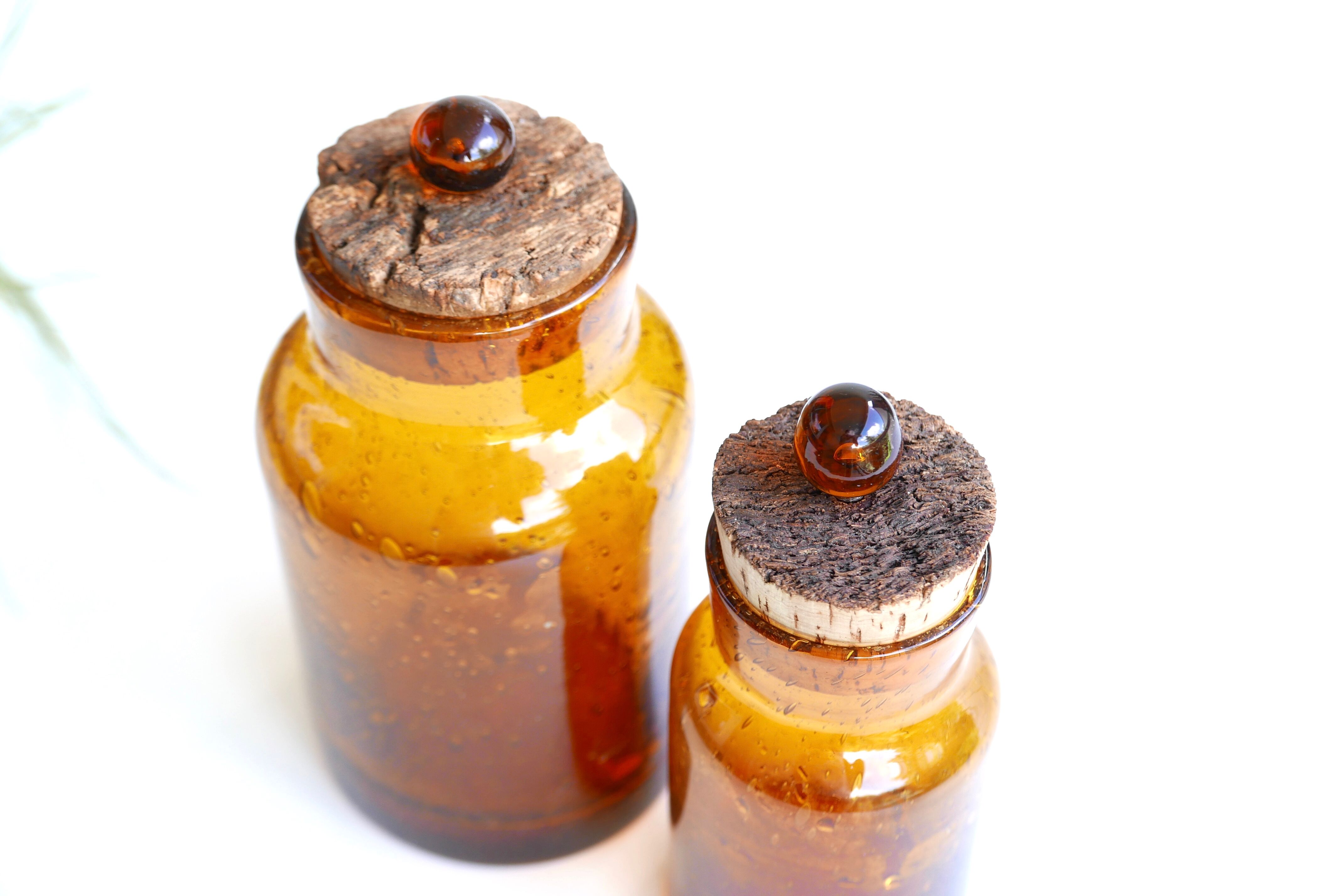 2 amber blown glass jars, cork stoppers