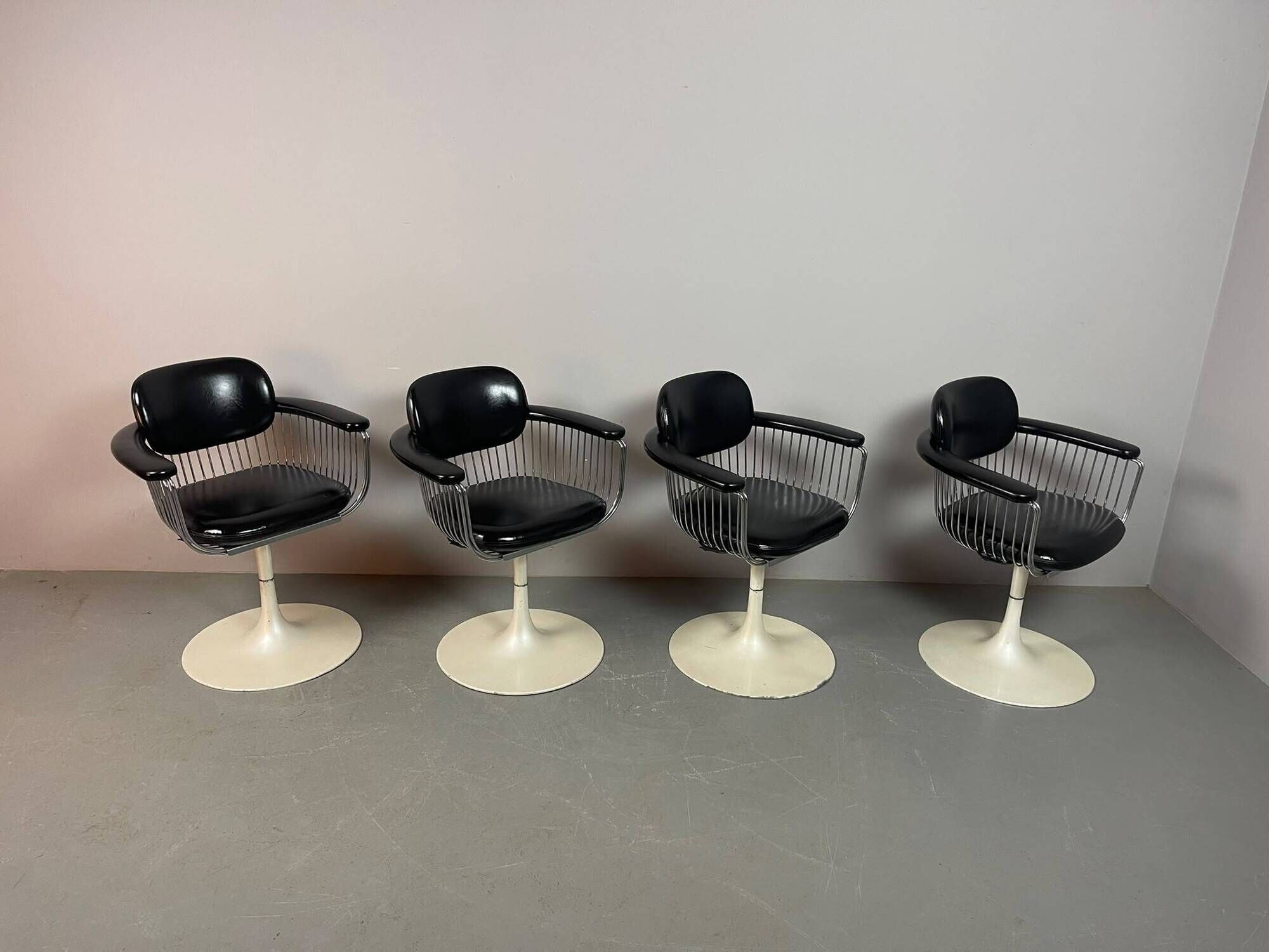 A striking set of four vintage swivel dining chairs