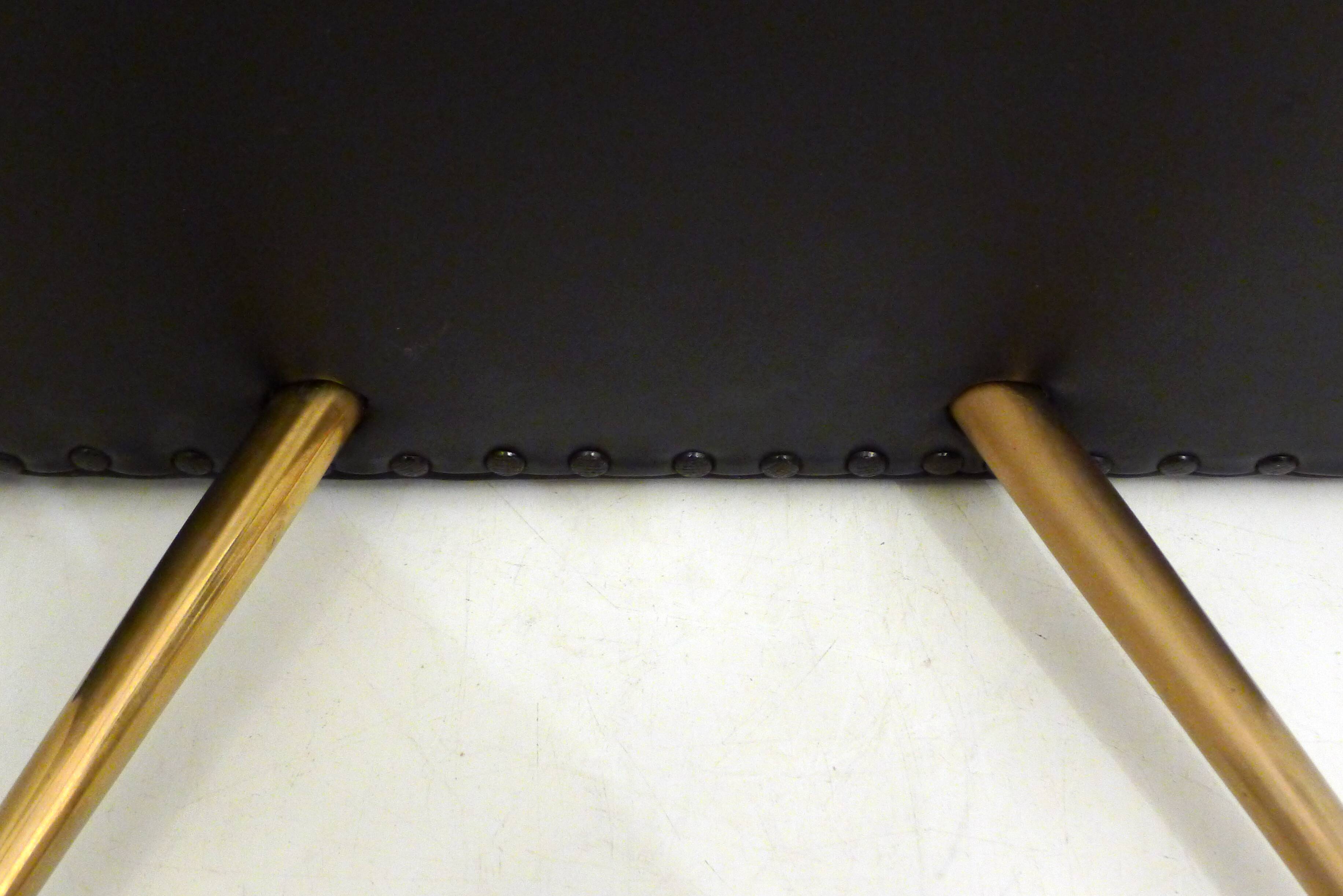 Footrest / stool 1960s with tapered gold legs & faux leather seat