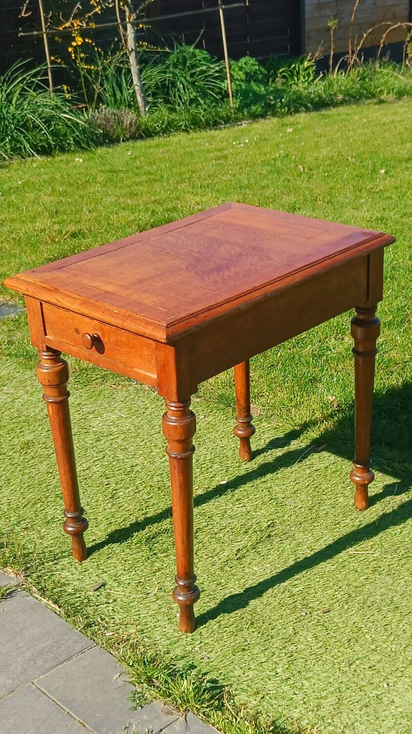 Antique solid wood table with a through drawer.