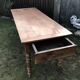 Antique farmhouse table in solid cherry wood with 2 drawers and 1 pull-out at the end with turned legs.