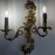 Pair of Italian Hollywood Regency wall lights in iron and gilded sheet metal.