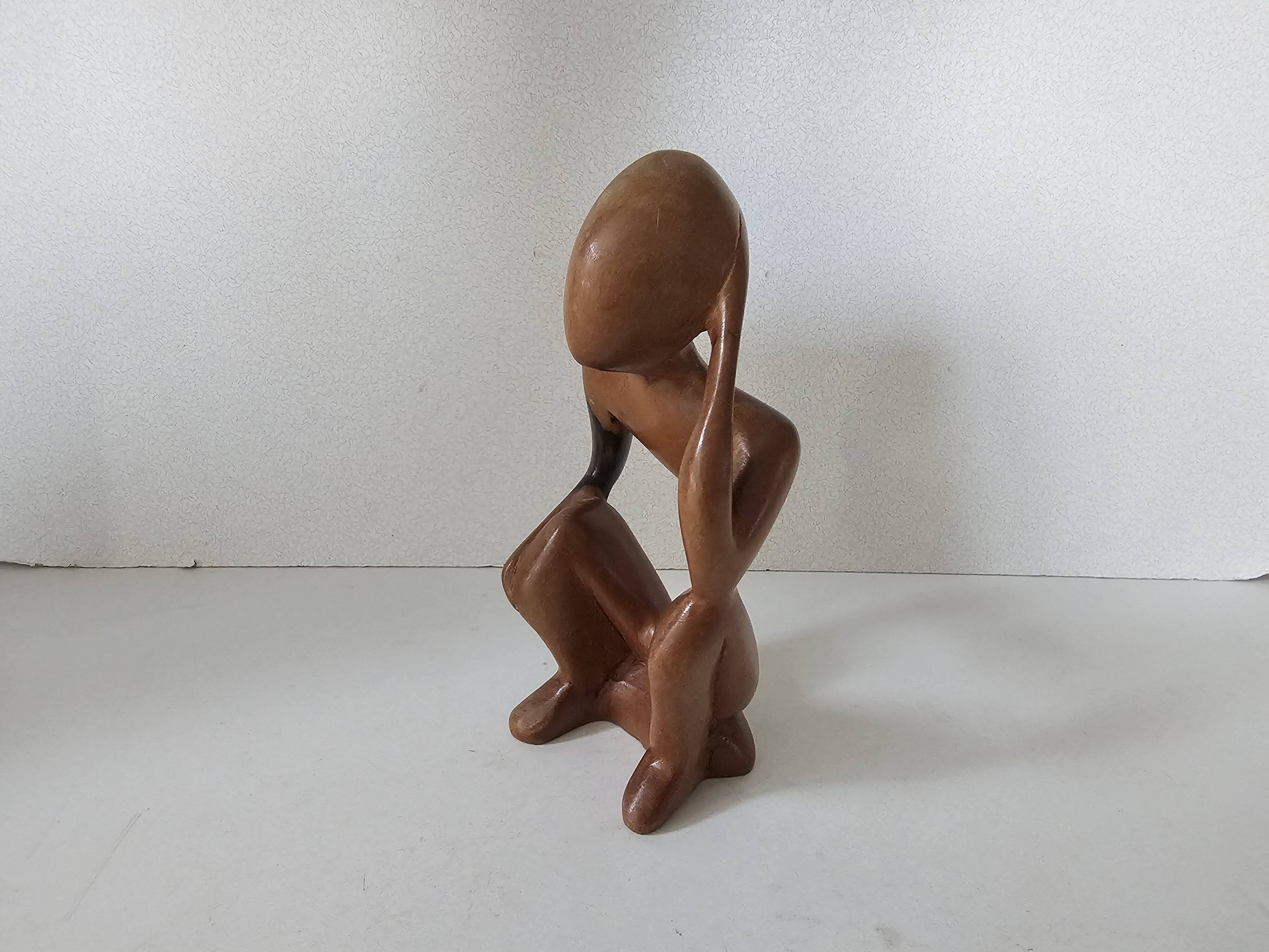 Wooden statuette sculpture of a thinking man design