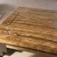 Coffee table in travertine with mother-of-pearl inlays.