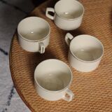 A set of 4 Sarreguemines ecru and gold earthenware cups