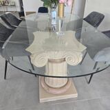 Oval glass table with marble column.