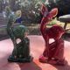 Pair of Art Deco deer by Charles Lemanceau in red and green ceramic.