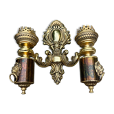 Wall light with 2 branches in baroque brass lion design.